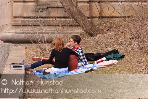 Two people play guitar and listen to the old vinyl near Lake of the Isles.